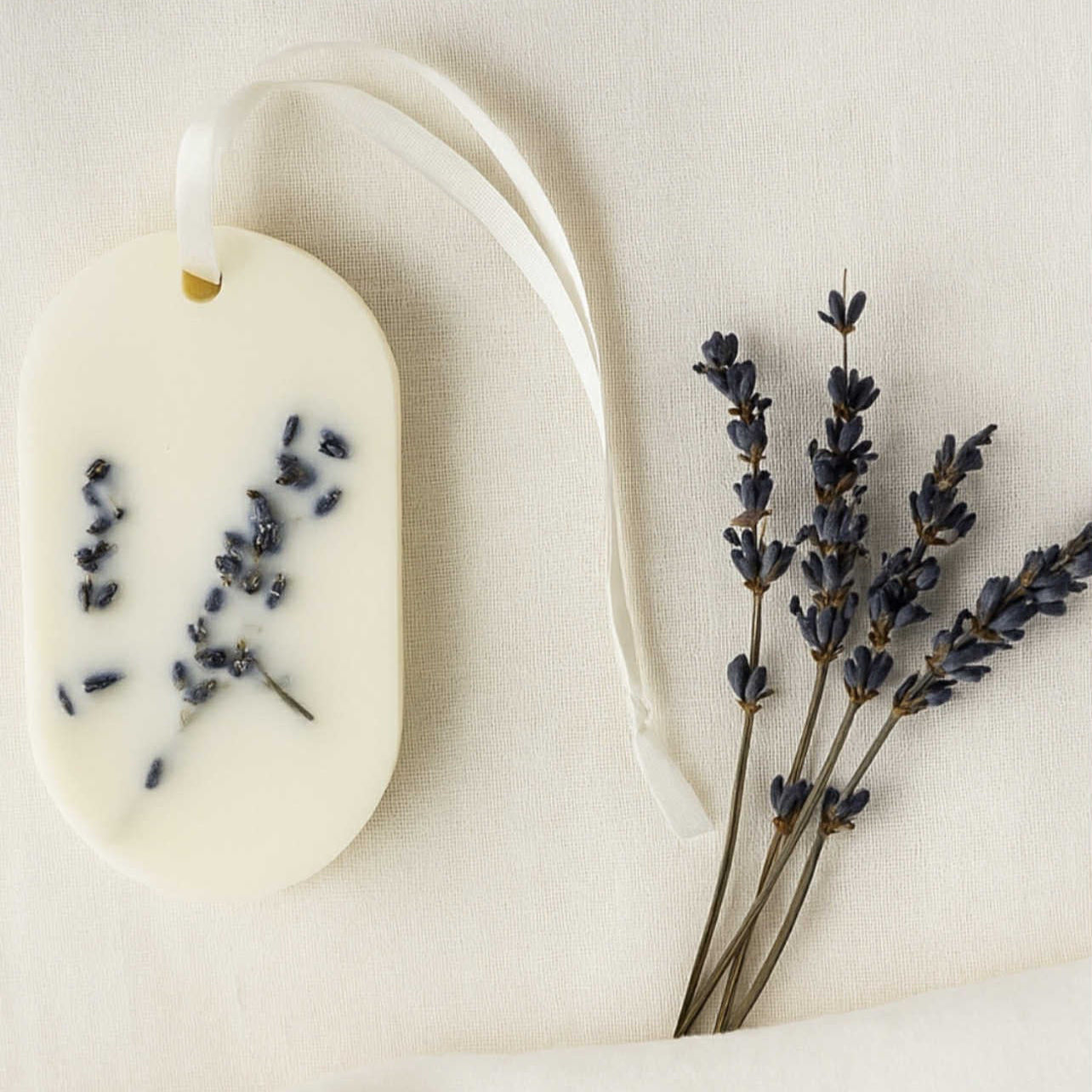 White soap bar with lavender buds on a white background